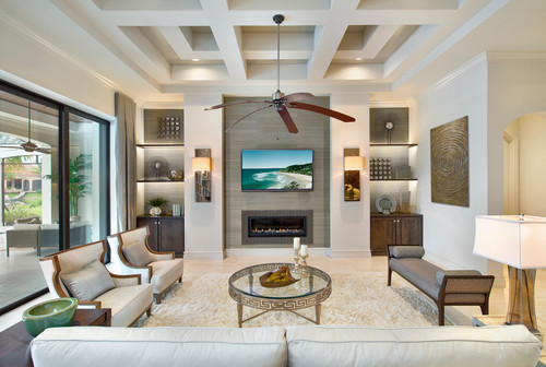 Living room with matching color walls and ceiling, featuring a ceiling fan and a television.