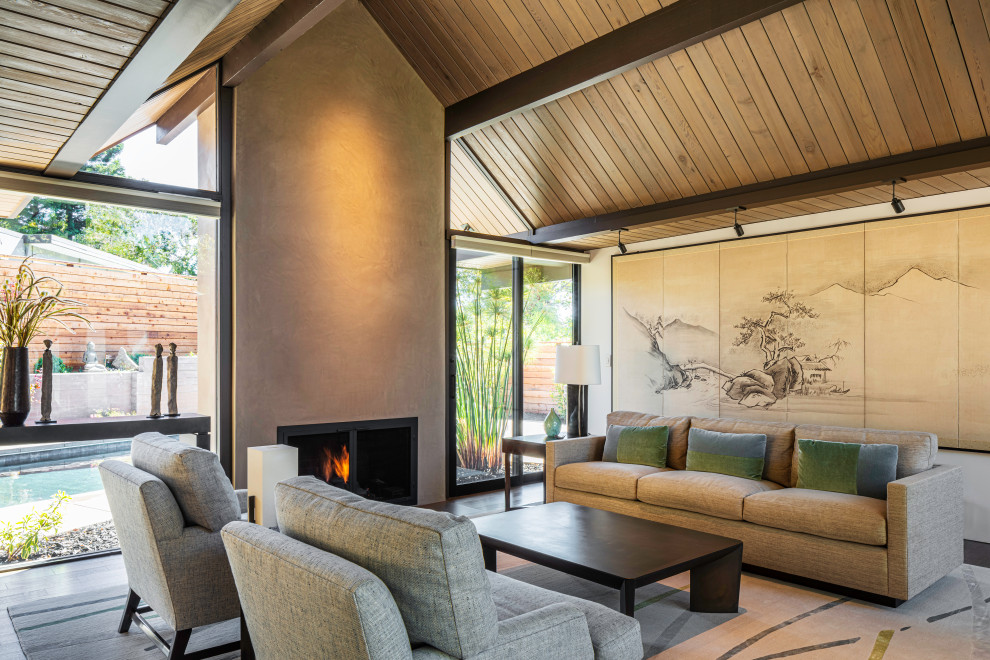 Diseño de salón abovedado de estilo zen con todas las chimeneas, vigas vistas y madera