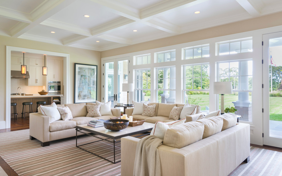 This is an example of a large classic open plan living room in Boston with beige walls, dark hardwood flooring, no tv and brown floors.