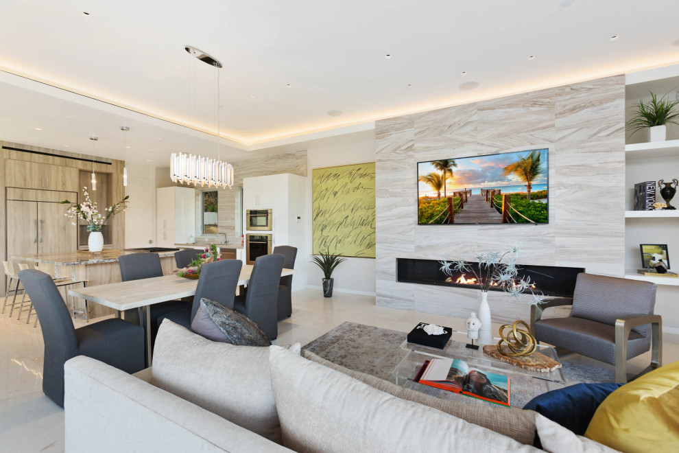 Example of a large trendy open concept porcelain tile and beige floor living room design in Los Angeles with white walls, a ribbon fireplace, a stone fireplace and a wall-mounted tv