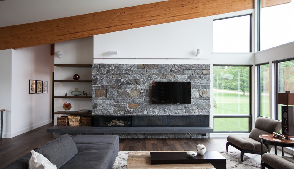 Photo of a contemporary open plan living room in Grand Rapids with white walls, dark hardwood flooring, a ribbon fireplace, a stone fireplace surround and a wall mounted tv.