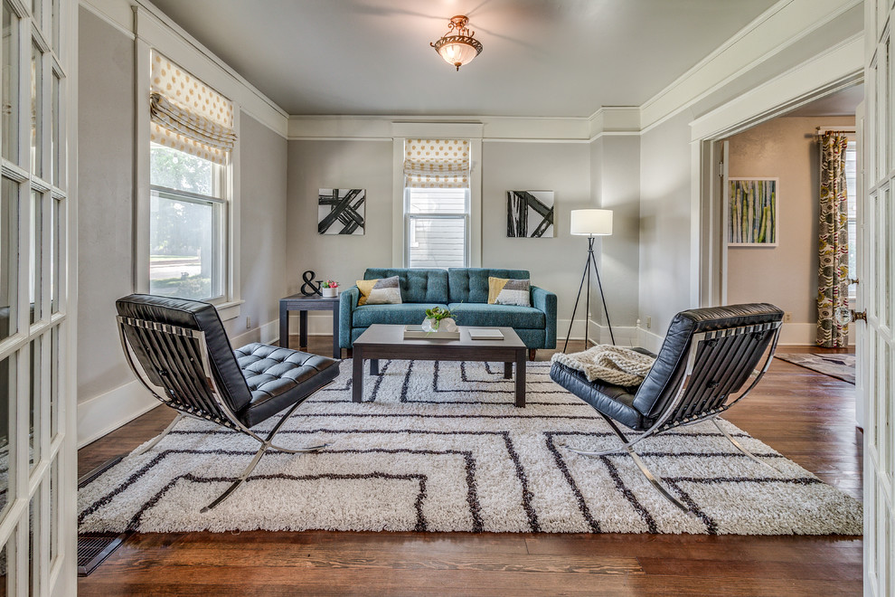 Photo of a classic formal and grey and teal enclosed living room in Oklahoma City with grey walls, medium hardwood flooring and brown floors.