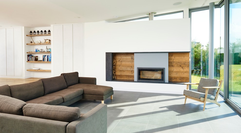 Photo of a large contemporary open plan living room in Devon with white walls, ceramic flooring and a standard fireplace.