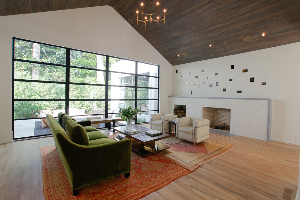 Photo of a contemporary living room in Atlanta with a standard fireplace and a brick fireplace surround.