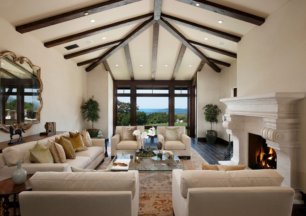 Tuscan dark wood floor living room photo in Los Angeles with beige walls and a standard fireplace