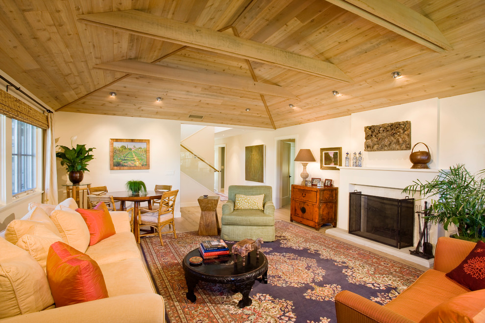 Example of a trendy living room design in Santa Barbara with white walls and a standard fireplace