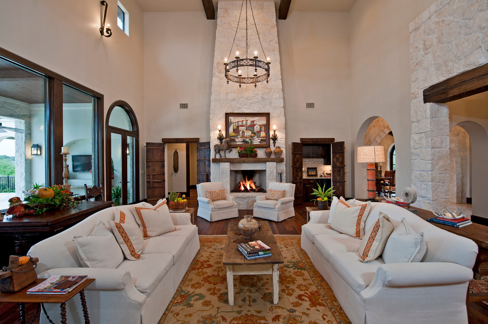 Living room - huge mediterranean formal and open concept medium tone wood floor living room idea in Austin with white walls, a standard fireplace and a stone fireplace