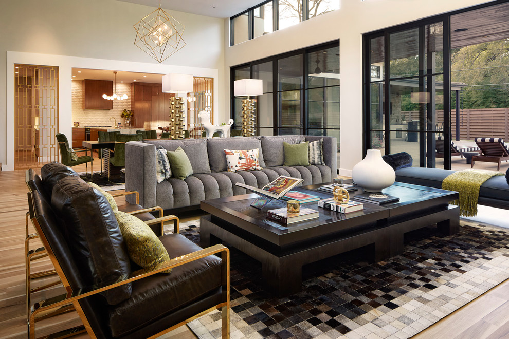Example of a trendy open concept light wood floor living room design in Dallas with white walls