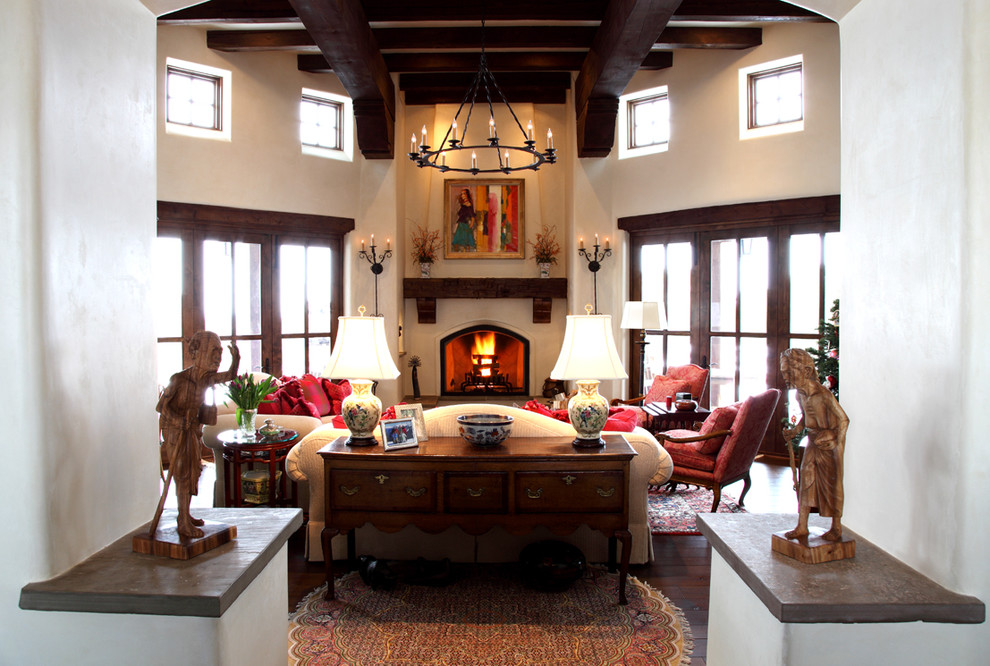 Inspiration for a large southwestern open concept dark wood floor living room remodel in Seattle with beige walls and a standard fireplace