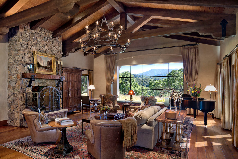 This is an example of a large open plan living room in San Francisco with a music area, brown walls, dark hardwood flooring, a standard fireplace, a stone fireplace surround and no tv.