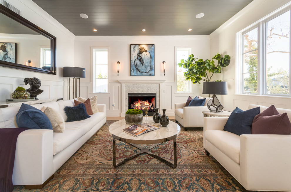 Classic formal living room in Los Angeles with white walls, a standard fireplace and a tiled fireplace surround.