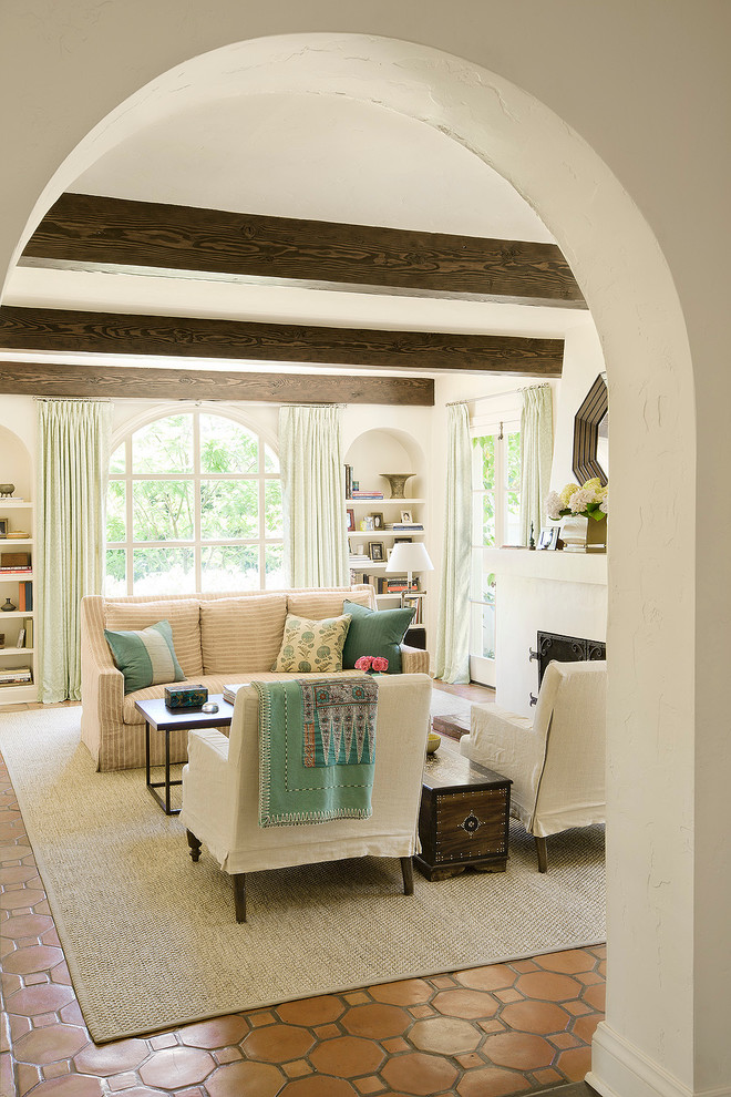 Inspiration for a large mediterranean enclosed terra-cotta tile living room remodel in Los Angeles with white walls and a standard fireplace