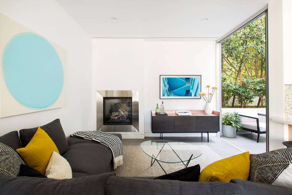 Fernseherloses Modernes Wohnzimmer mit weißer Wandfarbe, Betonboden und Kaminumrandung aus Metall in Los Angeles