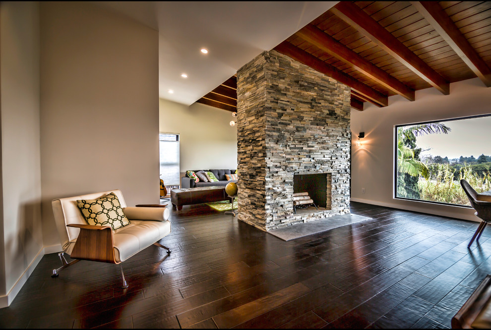 Example of a large minimalist open concept living room design in San Francisco with beige walls, a standard fireplace and a stone fireplace