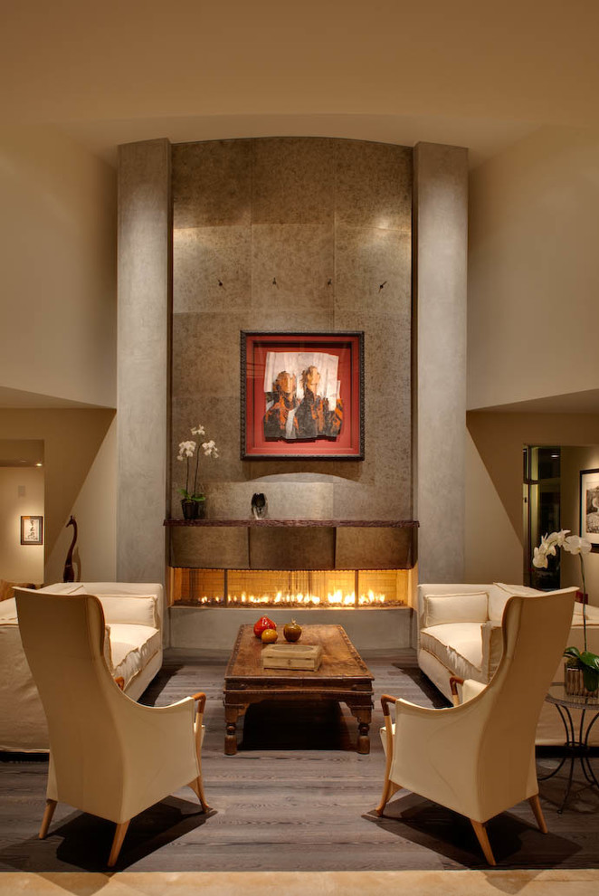 This is an example of a contemporary living room in Los Angeles with a ribbon fireplace.