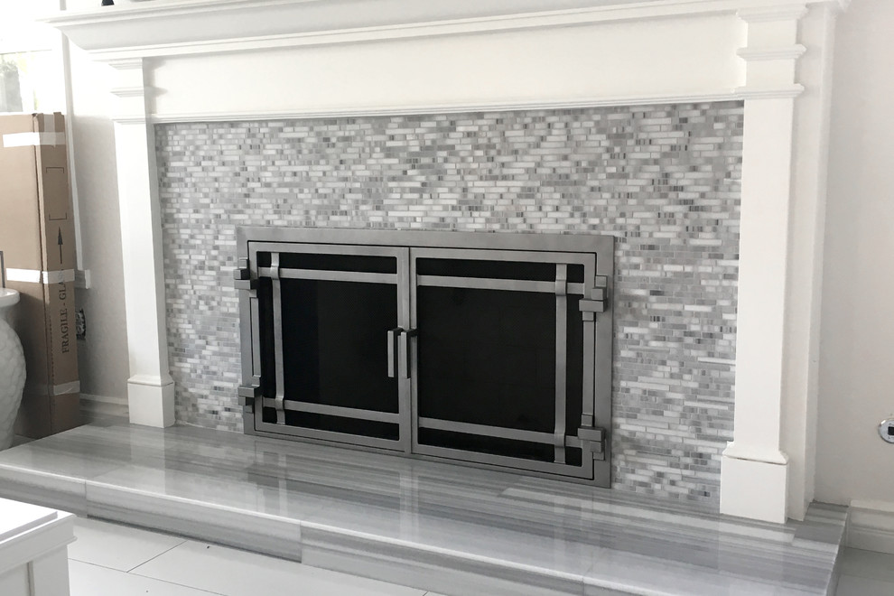 Example of a large trendy formal and open concept porcelain tile and white floor living room design in San Diego with white walls, a standard fireplace, a tile fireplace and no tv
