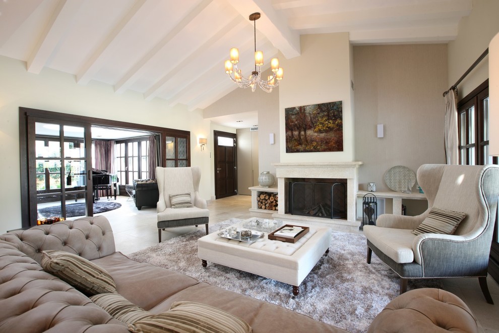 This is an example of a mediterranean living room in Manchester with beige walls and a standard fireplace.