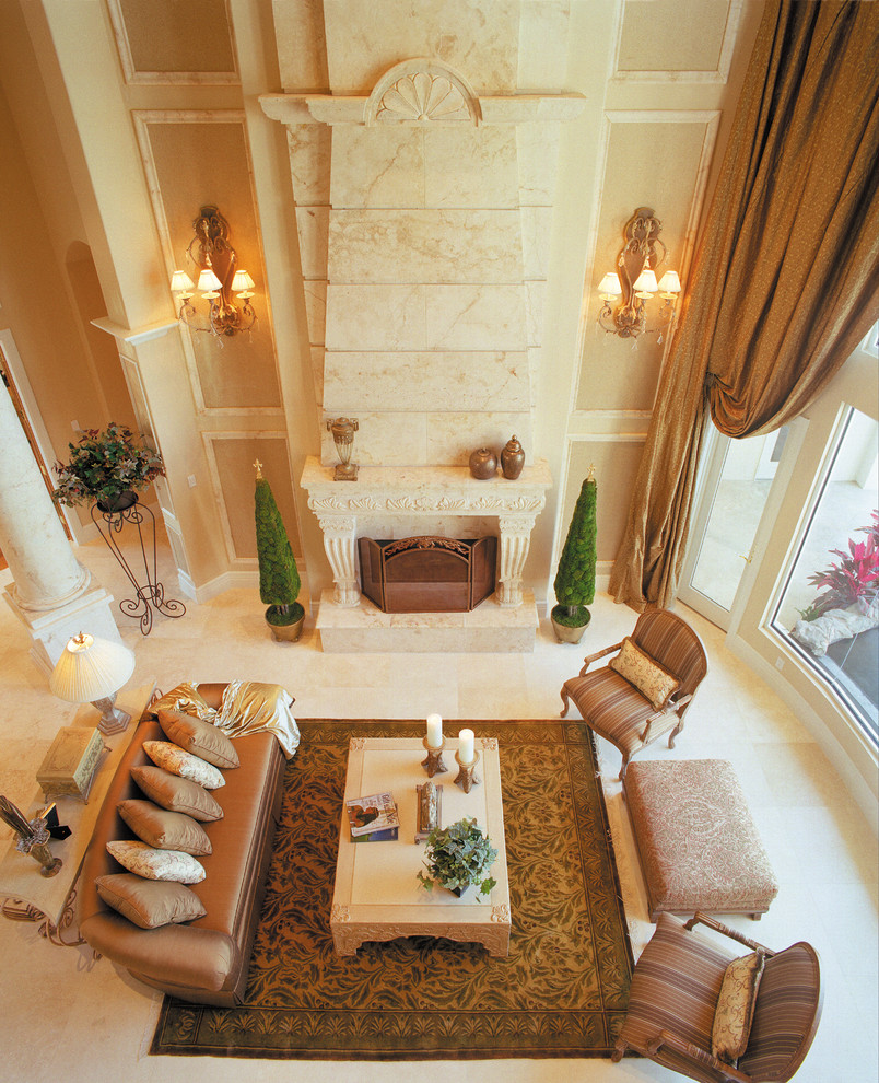 Example of a large tuscan formal and open concept living room design in Miami with beige walls, a standard fireplace, a stone fireplace and no tv