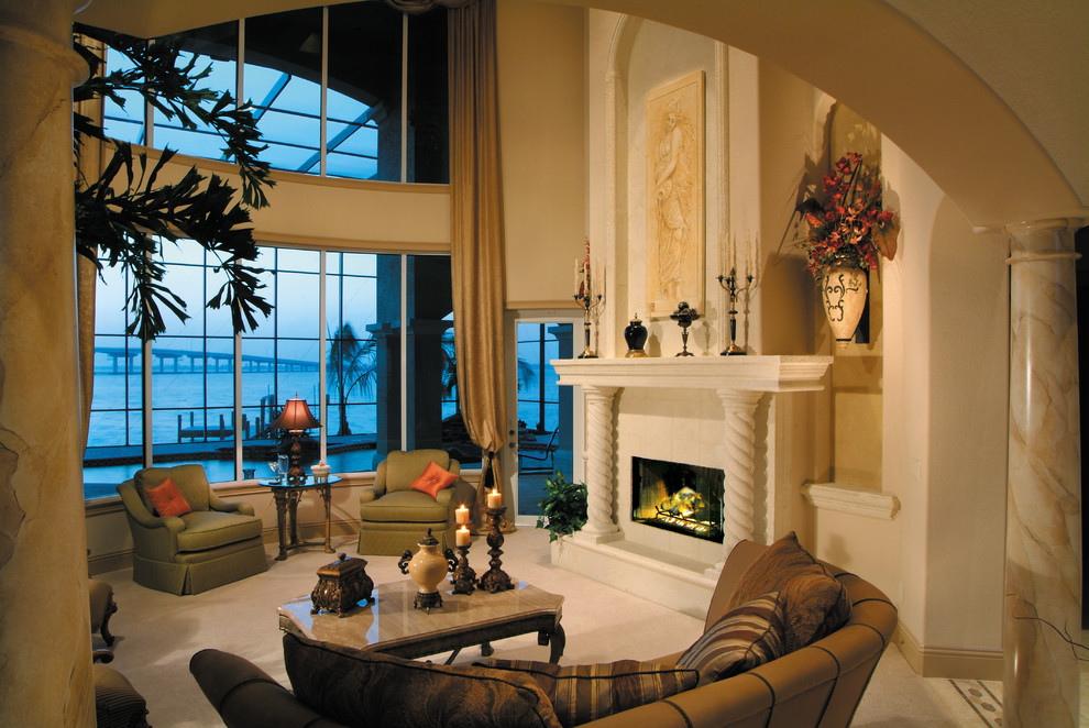 Example of a large tuscan formal and enclosed ceramic tile living room design in Miami with beige walls, a standard fireplace, a stone fireplace and no tv