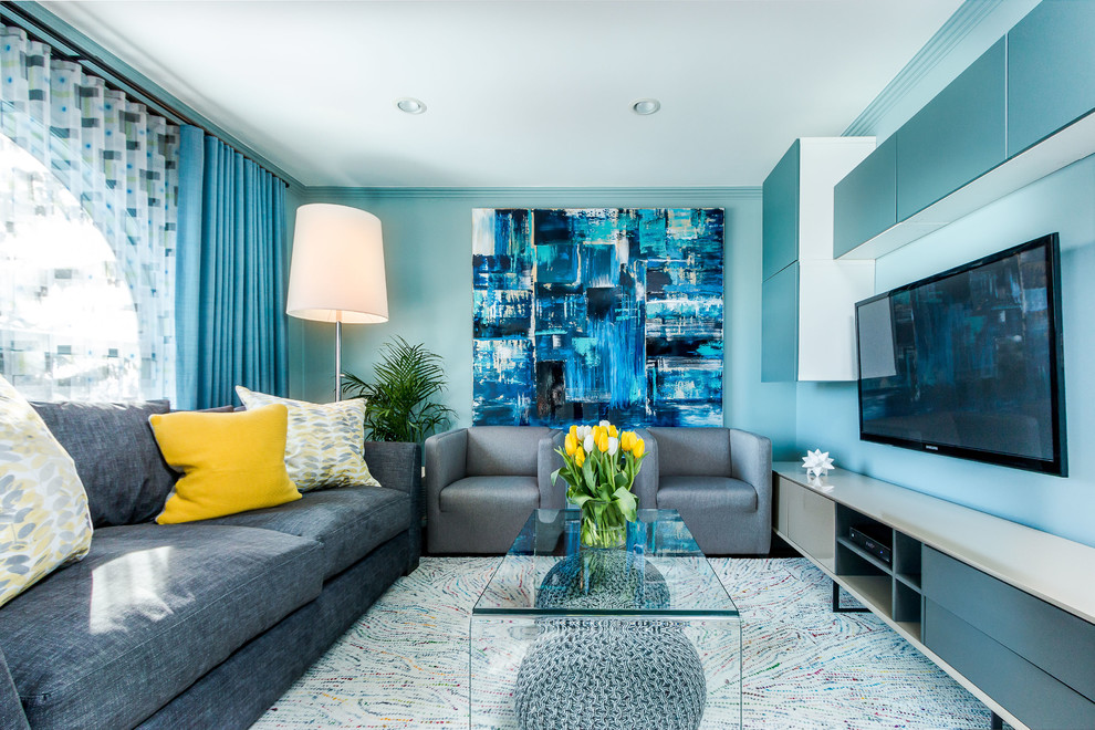 Ejemplo de salón para visitas cerrado escandinavo de tamaño medio con paredes azules, suelo de madera en tonos medios y televisor colgado en la pared