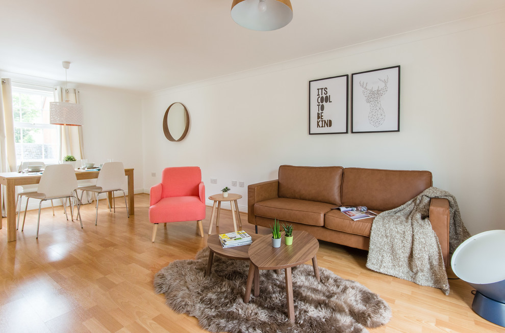 Living room - mid-sized scandinavian enclosed laminate floor and brown floor living room idea in Berkshire with white walls and a tv stand