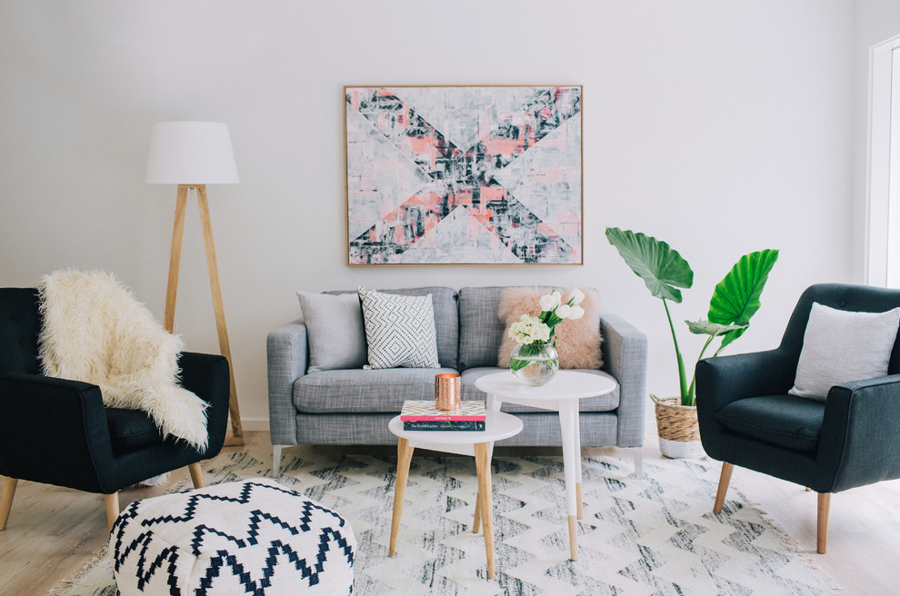 Example of a danish formal light wood floor living room design in Sydney with gray walls