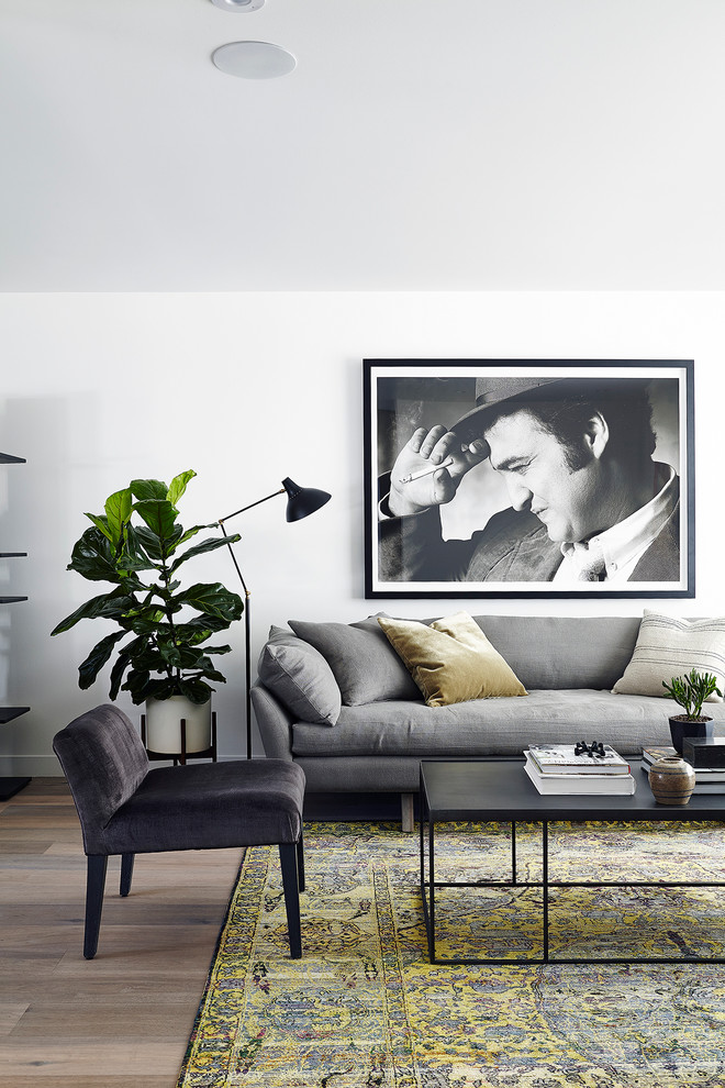 Inspiration for a scandinavian light wood floor and beige floor living room remodel in Toronto with white walls