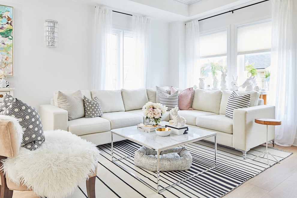 Example of a small danish open concept light wood floor living room design in Toronto with white walls, a standard fireplace, a wood fireplace surround and no tv
