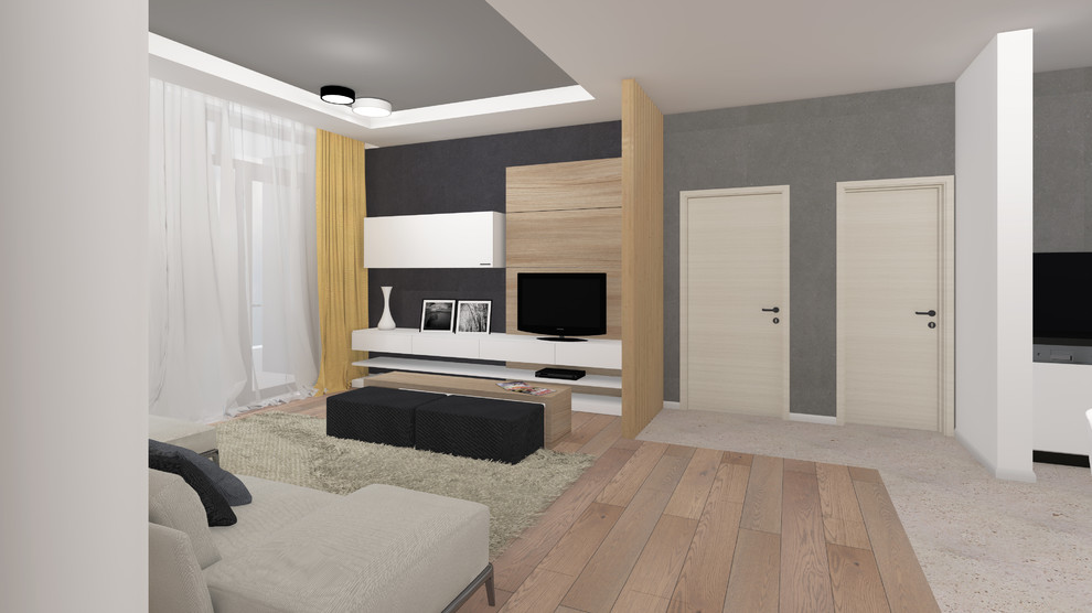 Modelo de biblioteca en casa abierta escandinava de tamaño medio con paredes grises, suelo de madera clara y pared multimedia
