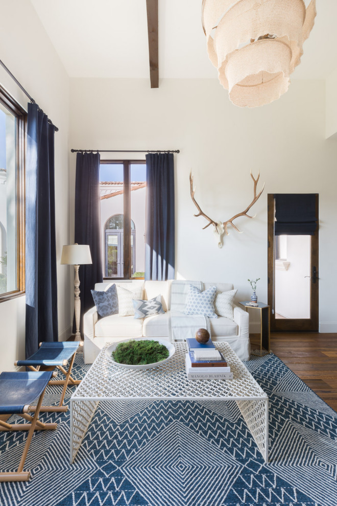 Mediterranean living room in Phoenix with white walls, dark hardwood flooring and brown floors.