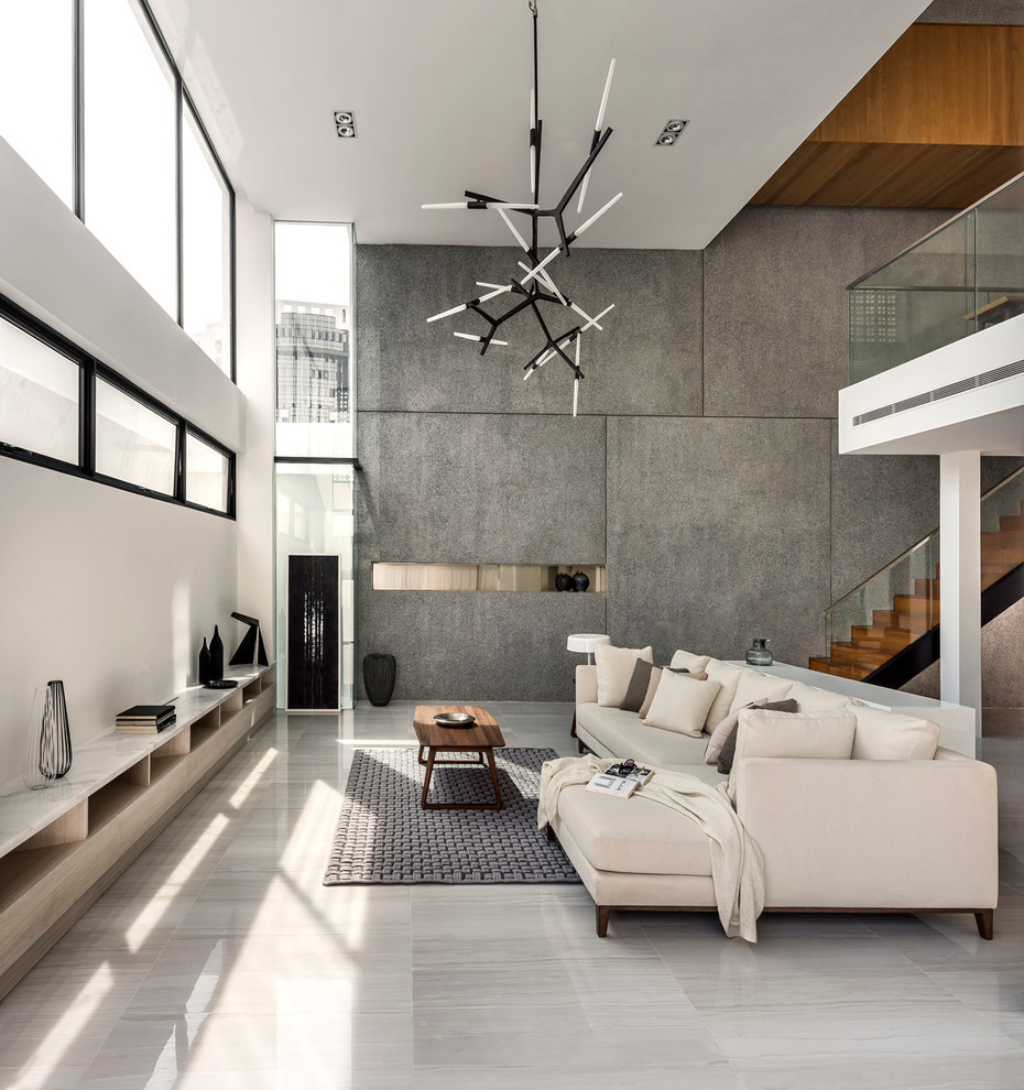 Стильный дизайн: парадная, открытая гостиная комната в современном стиле с серыми стенами без телевизора - последний тренд