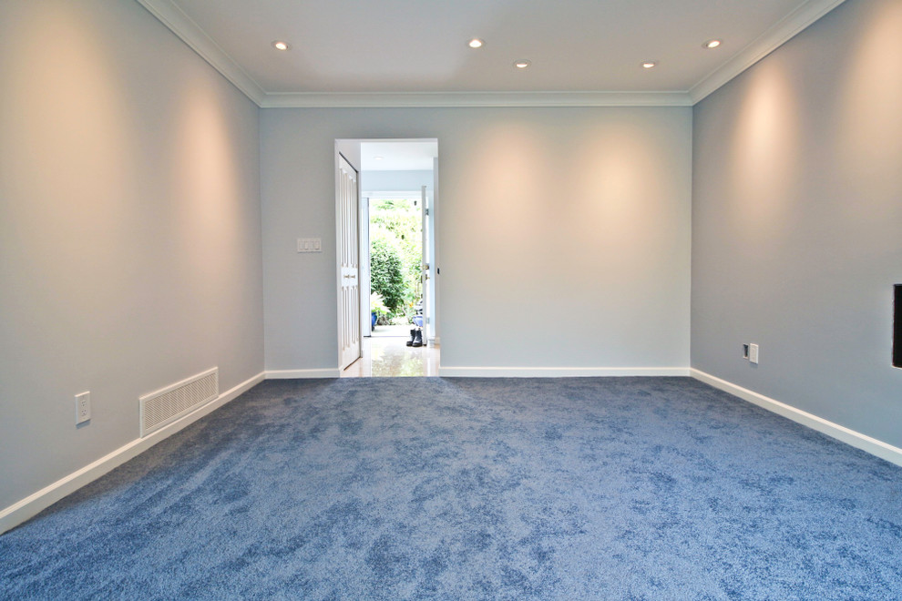 Medium sized traditional formal enclosed living room in Vancouver with blue walls, carpet, a hanging fireplace and a metal fireplace surround.