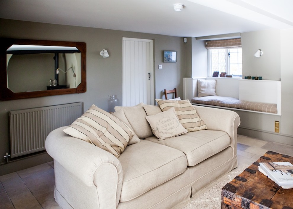Living room - coastal limestone floor living room idea in Kent with gray walls
