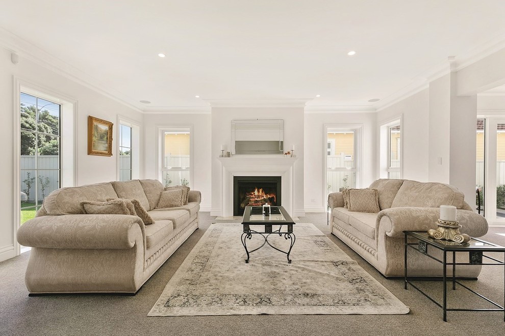 Large elegant formal and enclosed carpeted and beige floor living room photo in Wellington with white walls, a standard fireplace, a wood fireplace surround and no tv
