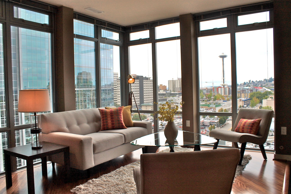 This is an example of a medium sized contemporary living room in Seattle with grey walls and dark hardwood flooring.