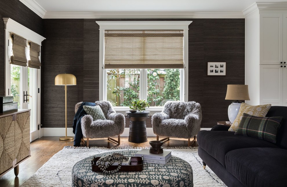 Photo of a traditional living room in Seattle with black walls, medium hardwood flooring and brown floors.