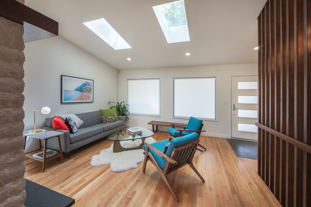 Example of a 1950s vaulted ceiling living room design in Seattle with white walls