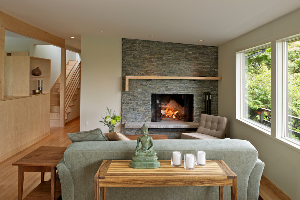 Inspiration for a mid-sized contemporary formal and open concept light wood floor living room remodel in Seattle with beige walls, a standard fireplace, a stone fireplace and no tv