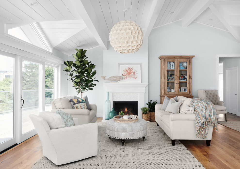 Design ideas for a medium sized beach style formal open plan living room in San Francisco with white walls, medium hardwood flooring, a standard fireplace, brown floors, no tv and a tiled fireplace surround.