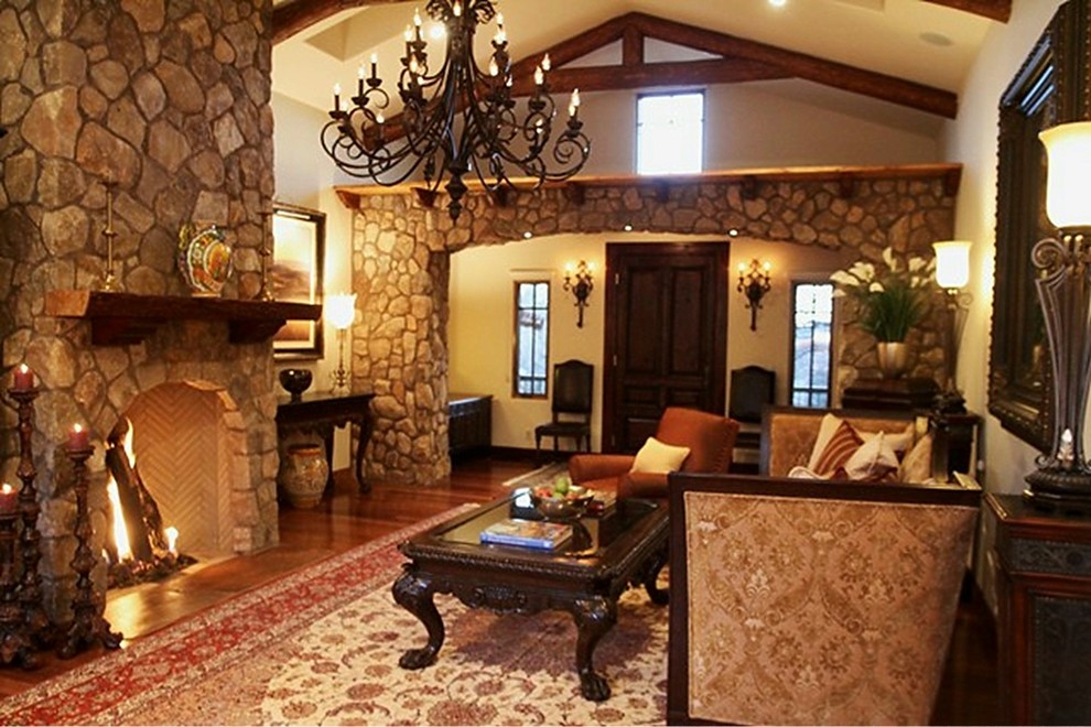Eclectic formal and open concept medium tone wood floor living room photo in Phoenix with beige walls, a stone fireplace and a concealed tv