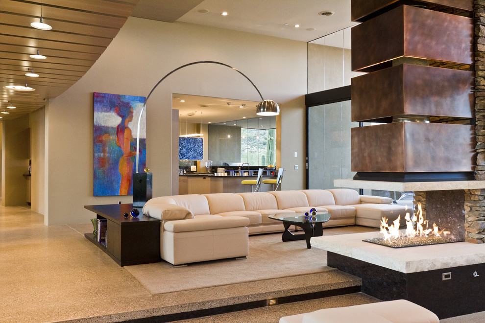 Southwest living room photo in Phoenix with beige walls and a two-sided fireplace