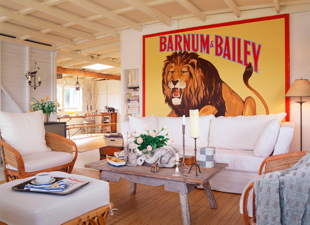 This is an example of an eclectic living room in San Francisco with white walls and medium hardwood flooring.