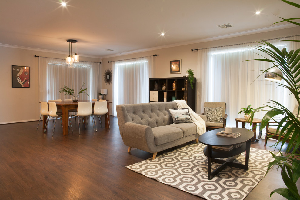 Design ideas for a traditional living room in Melbourne with laminate floors.