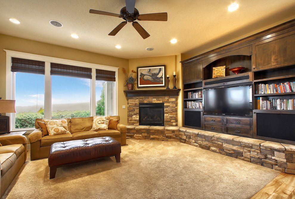 Inspiration for a medium sized classic open plan living room in Boise with a reading nook, yellow walls, light hardwood flooring, a standard fireplace, a stone fireplace surround and a built-in media unit.