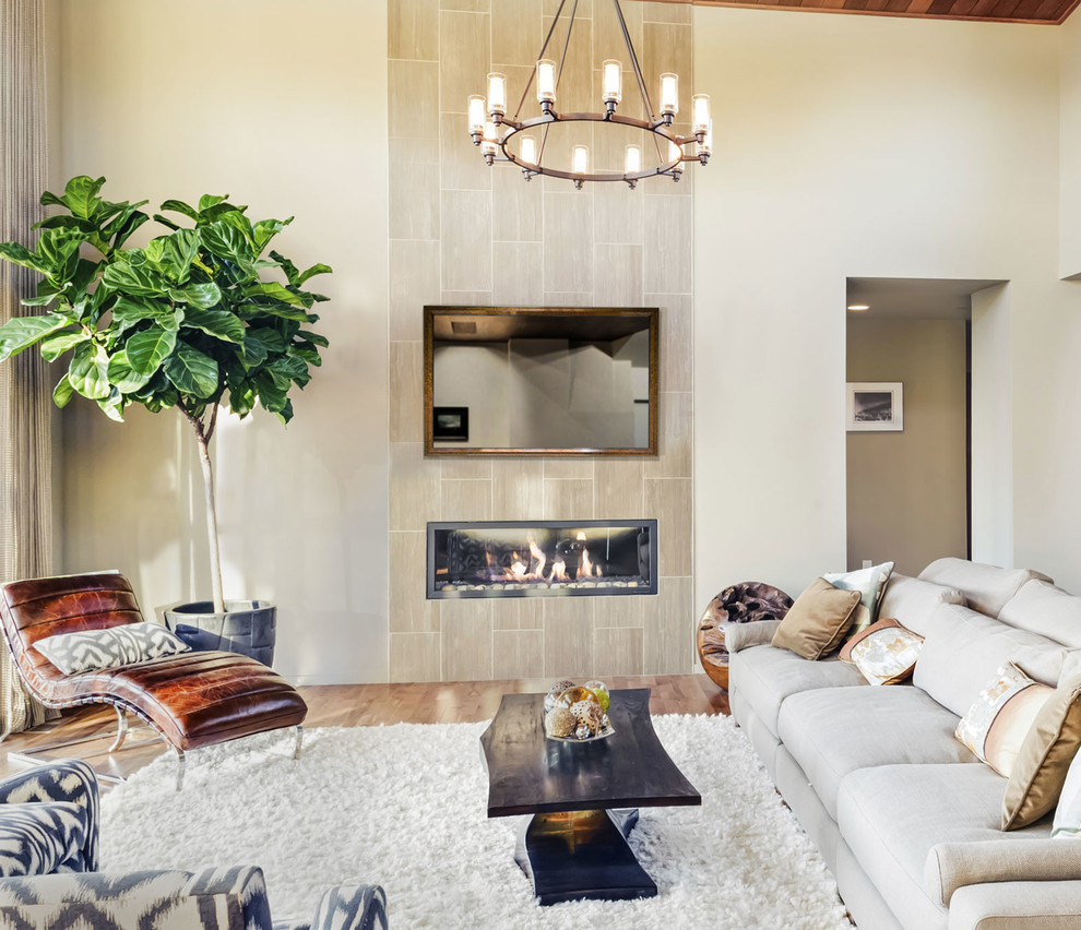 Mid-sized eclectic formal and open concept light wood floor and brown floor living room photo in Other with beige walls, a two-sided fireplace, a metal fireplace and a concealed tv
