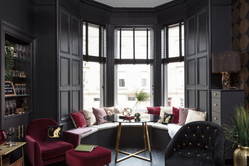 Small trendy enclosed dark wood floor and black floor living room photo in Other with black walls