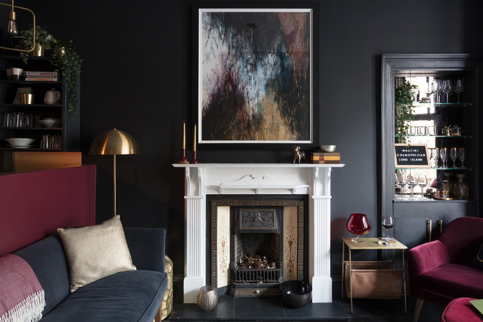 Inspiration pour un petit salon design fermé avec un mur noir, parquet foncé, une cheminée standard, un manteau de cheminée en bois et un sol noir.