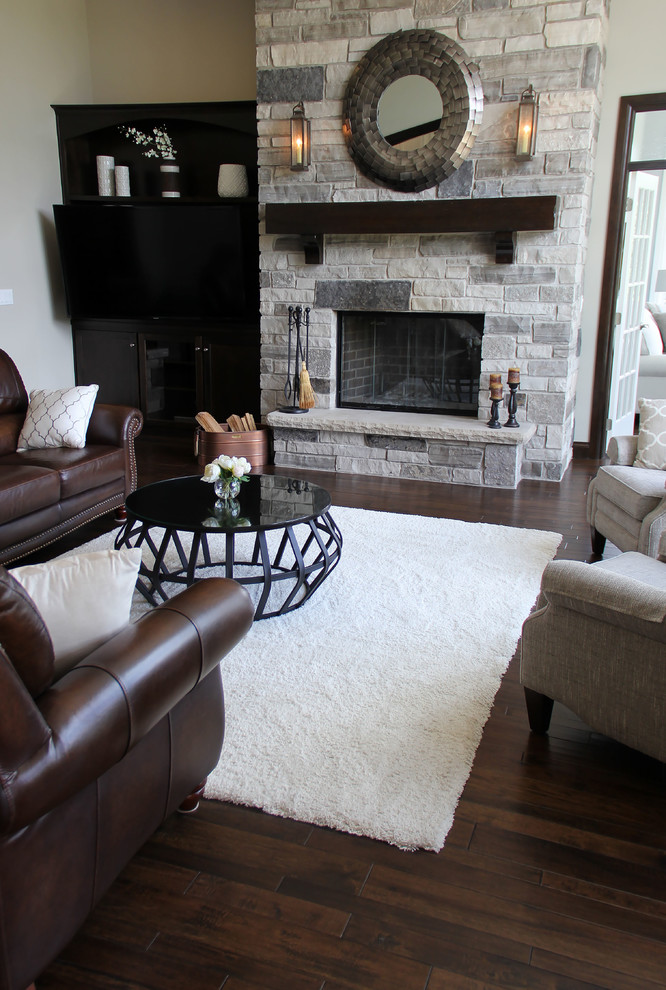 Inspiration for a medium sized romantic open plan living room in Other with grey walls, medium hardwood flooring, a standard fireplace, a stone fireplace surround, no tv and brown floors.