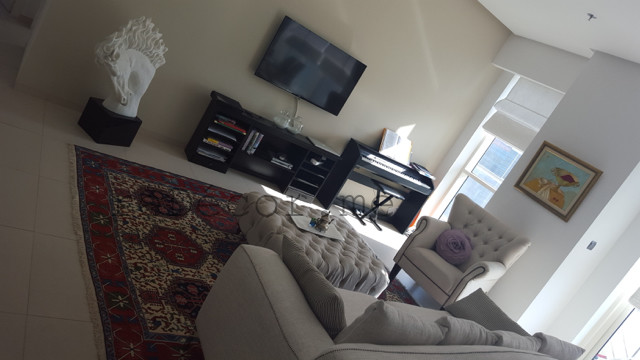 На фото: парадная, открытая гостиная комната среднего размера в стиле шебби-шик с бежевыми стенами и телевизором на стене