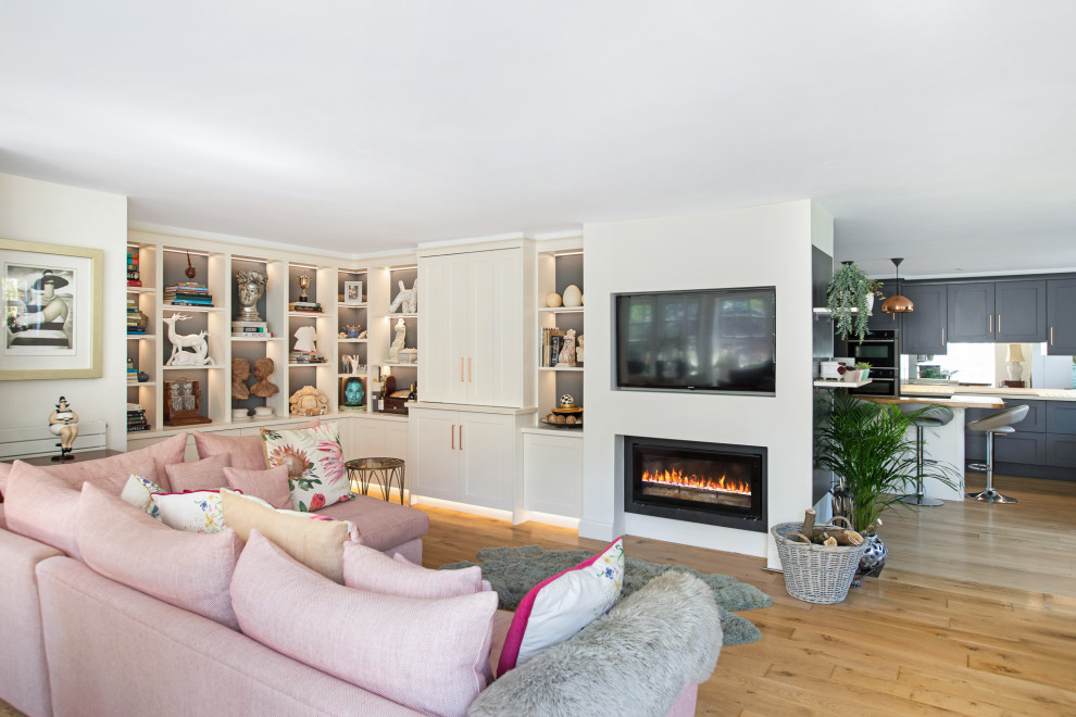 Inspiration for a large timeless formal and open concept living room remodel in Hertfordshire with a media wall